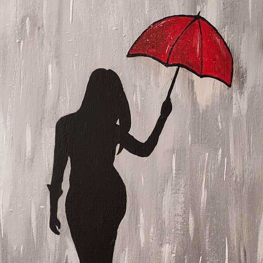 Silhouette of lady holding an umbrella